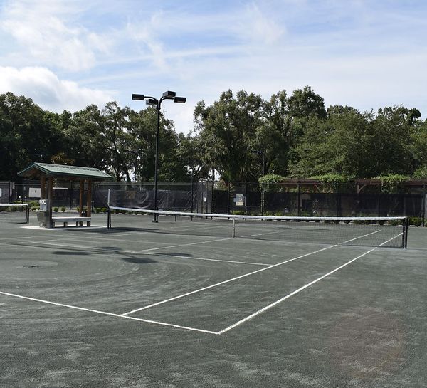 Pavilion and covered viewing area alongside the courts